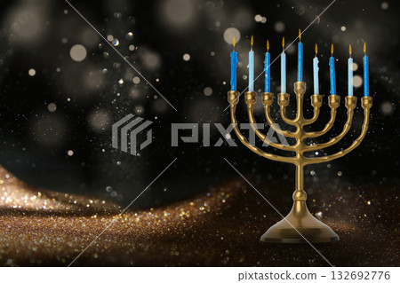 Menorah with blue candles lit, surrounded by shimmering lights Menorah with blue candles lit, surrounded by shimmering lights 132692776