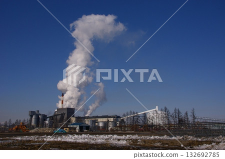 Smoke coming out of chimneys from a sugar beet factory 1 132692785