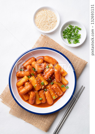 Korean Tteokbokki (simmered rice cake) and sausage with spicy sauce Korean Tteokbokki (simmered rice cake) and sausage with spicy sauce 132693131