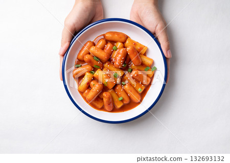 Korean Tteokbokki (simmered rice cake) and sausage with spicy sauce Korean Tteokbokki (simmered rice cake) and sausage with spicy sauce 132693132