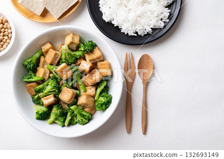 Stir fried tofu and broccoli with soy sauce eating with cooked rice, Asian vegan food, Top view 132693149