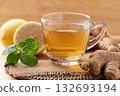 Lemon and ginger tea in cup glass with mint leaf, Healthy hot drink 132693194