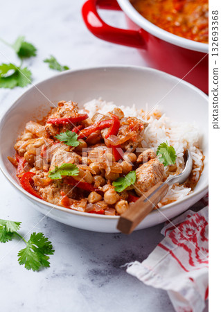 Tikka masala with chicken, chickpeas and rice in bowl. Tikka masala with chicken, chickpeas and rice in bowl. 132693368