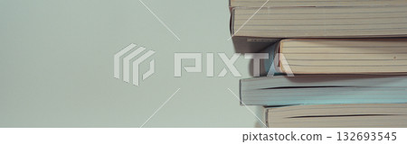 stack of book on table with soft focus library or bookstore background 132693545