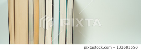 stack of book on table with soft focus library or bookstore background 132693550