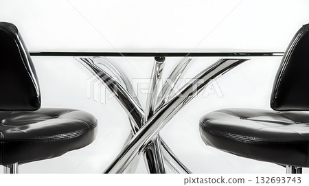 A black chair is sitting next to a glass table 132693743