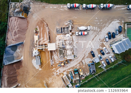 Aerial view of concrete production plant with mixer trucks and silos Aerial view of concrete production plant with mixer trucks and silos 132693964