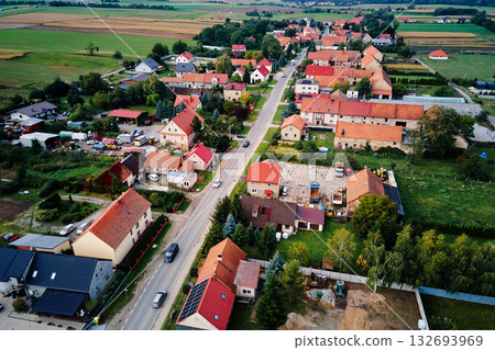 Aerial view of small rural town with houses and main road surrounded by fields Aerial view of small rural town with houses and main road surrounded by fields 132693969