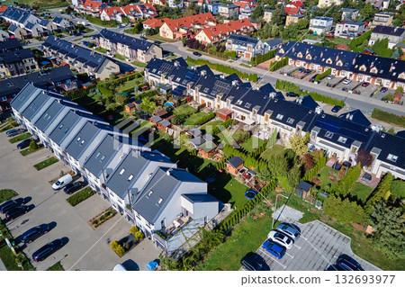Aerial view of modern residential neighborhood with townhouses and parking areas Aerial view of modern residential neighborhood with townhouses and parking areas 132693977