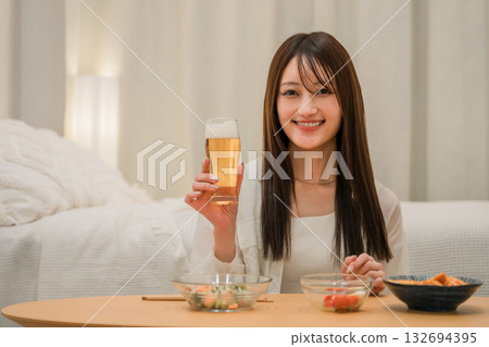 年輕的亞洲女性在家中臥室喝酒(啤酒、在家喝酒、飲酒習慣) 年輕的亞洲女性在家中臥室喝酒(啤酒、在家喝酒、飲酒習慣) 132694395