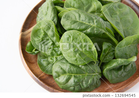 Baby spinach on a wooden plate 132694545