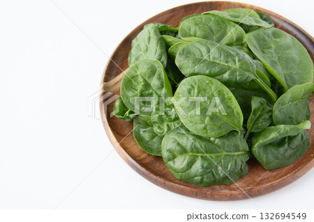 Baby spinach on a wooden plate 132694549