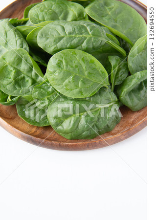 Baby spinach on a wooden plate 132694550