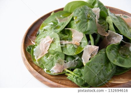 Baby spinach salad on a wooden plate 132694616