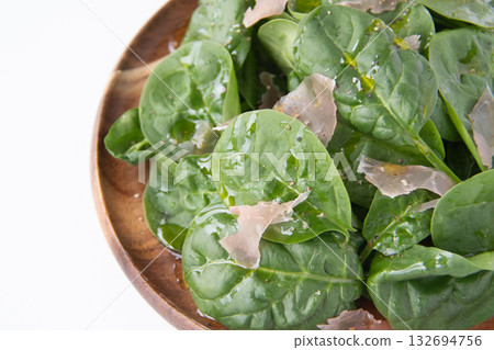 Baby spinach salad on a wooden plate 132694756