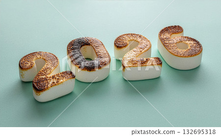 A 3D render of the number 2026 as toasted marshmallows on a mint green background. 132695318