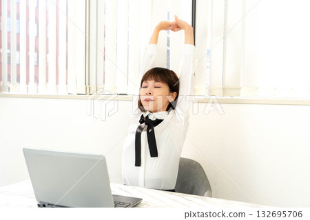 A woman growing at the desk A woman growing at the desk 132695706