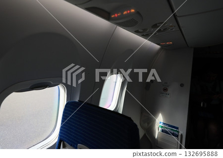 Airplane window with seats retracted Airplane window with seats retracted 132695888