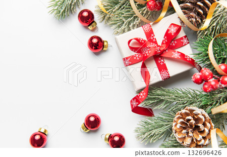 Christmas giftbox with pine branches and ornaments 132696426