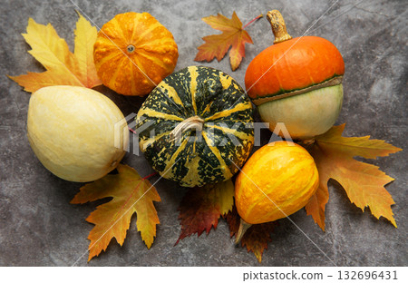 Autumn gourds and leaves creating a seasonal still life Autumn gourds and leaves creating a seasonal still life 132696431