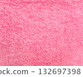 Terry towel or carpet of pink color. Background with fluffy towel terry cloth. Natural cotton fabric texture. Long pile canvas. Close-up of soft cotton terry cloth. Material of domestic cotton rug 132697398