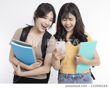 Happy Asian female students watching the smart phone 132698164