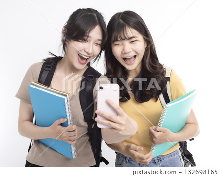 Excited Asian female students watching the smart phone 132698165