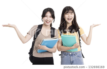 Two happy asian female students carrying notebooks and showing something 132698169