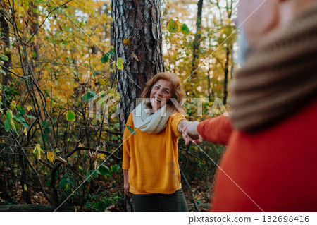Senior couple enjoying autumn walk in nature, Senior couple enjoying autumn walk in nature, 132698416