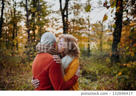 Romantic moment between senior couple, standing in autumn nature. Romantic moment between senior couple, standing in autumn nature. 132698417