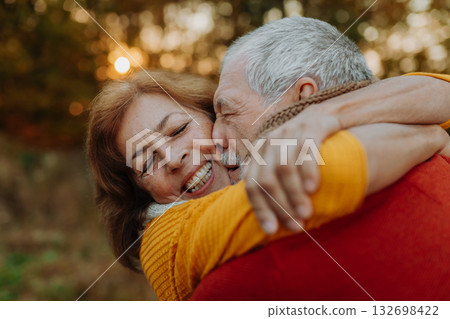 Romantic moment between senior couple, standing in autumn nature. Romantic moment between senior couple, standing in autumn nature. 132698422