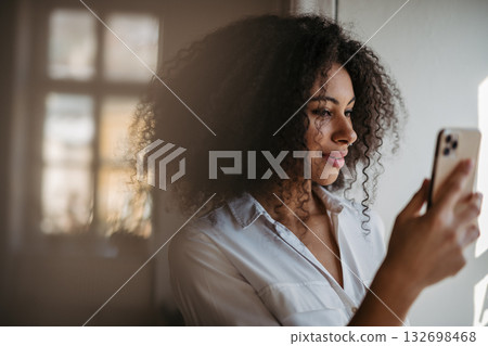 Portrait of young woman using smartphone. 132698468
