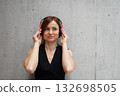 A portrait of young businesswoman, listening music. 132698505