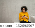 Woman scrolling on phone in modern office. 132698507