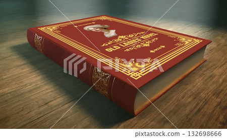 Antique red and gold hardback book laying on a wooden table, illuminated by atmospheric lighting, creating a vintage or historical mood 132698666