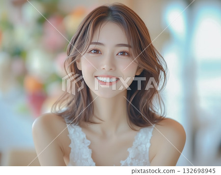 Portrait of a smiling young woman in a room decorated with colorful flowers Portrait of a smiling young woman in a room decorated with colorful flowers 132698945