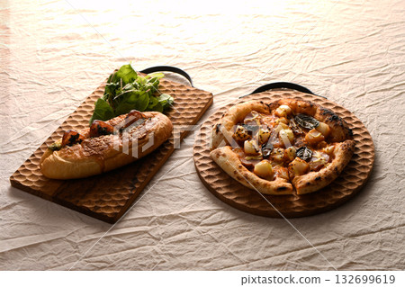 Table photo of pizza and hot dogs arranged on a wooden board 132699619