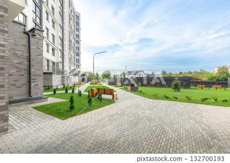 Modern Apartment Building with Green Courtyard and Benches 132700193