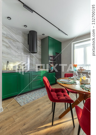 Modern Kitchen Interior with Green Cabinets and Red Velvet Chairs 132700195