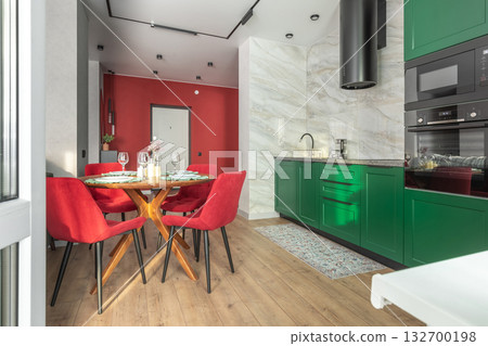 Colorful Modern Kitchen with Green Cabinets and Red Chairs Colorful Modern Kitchen with Green Cabinets and Red Chairs 132700198