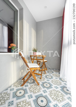 Cozy Balcony with Wooden Chairs and Patterned Tile Floor 132700199