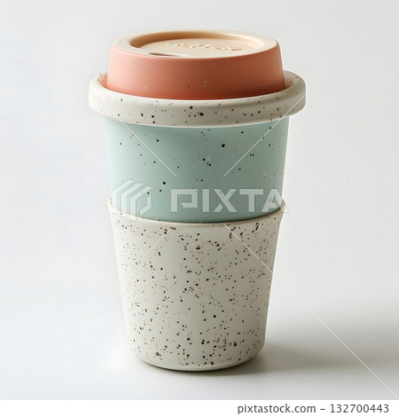 Mint and beige reusable travel mug with ribbed silicone sleeve; minimal studio still life for eco lifestyle. 132700443