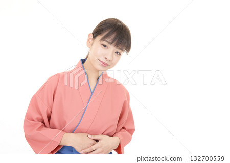 A smiling woman wearing an apron 132700559