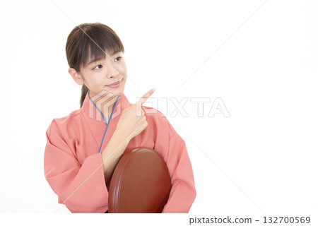 A smiling woman wearing an apron 132700569
