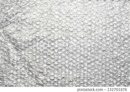 Bubble wrap packaging material with transparent plastic surface and air-filled bubbles, isolated background texture for protection, shipping, storage, moving, and wrapping. 132701876