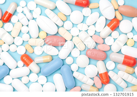 Various pills flat lay, top view on blue background, healthcare, medication, pharmacy, and medical concept Various pills flat lay, top view on blue background, healthcare, medication, pharmacy, and medical concept 132701915