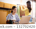 Two young asian businesswoman checking order clothes of customer for laptop computer. 132702420