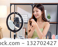 Young asian woman presenting and review cosmetic product with on social media. 132702427