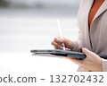 Close up hand caucasian businesswoman writing on digital tablet outdoors in city. 132702432