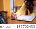Close up hand woman management online order in home office, writing inventory checklist on clipboard 132702433